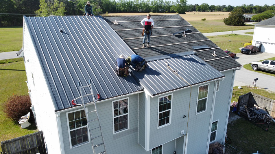 People working on a metal roof