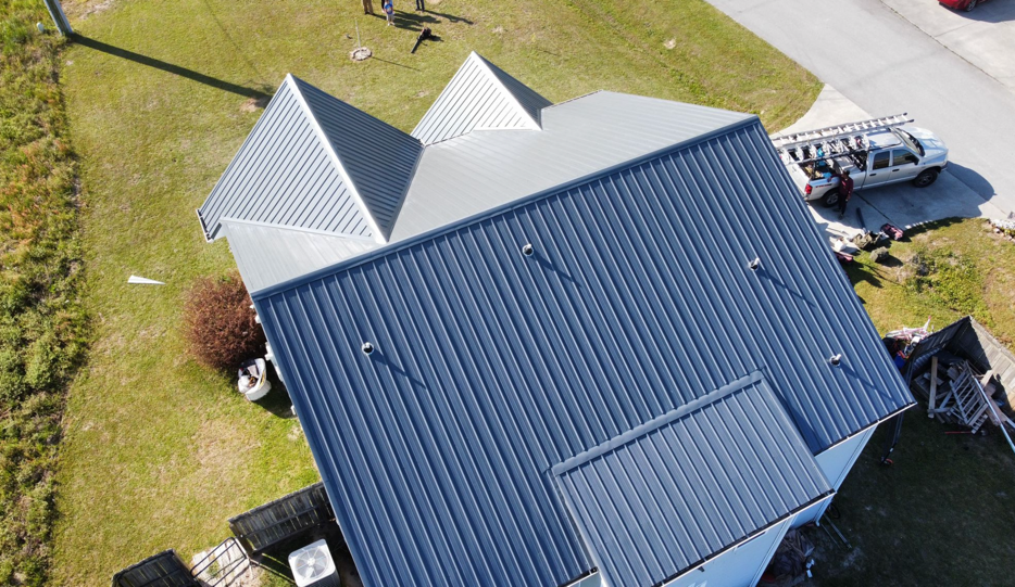 Top view of a house with a blue metal roof