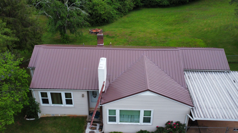 Top view of a house with a red metal roof