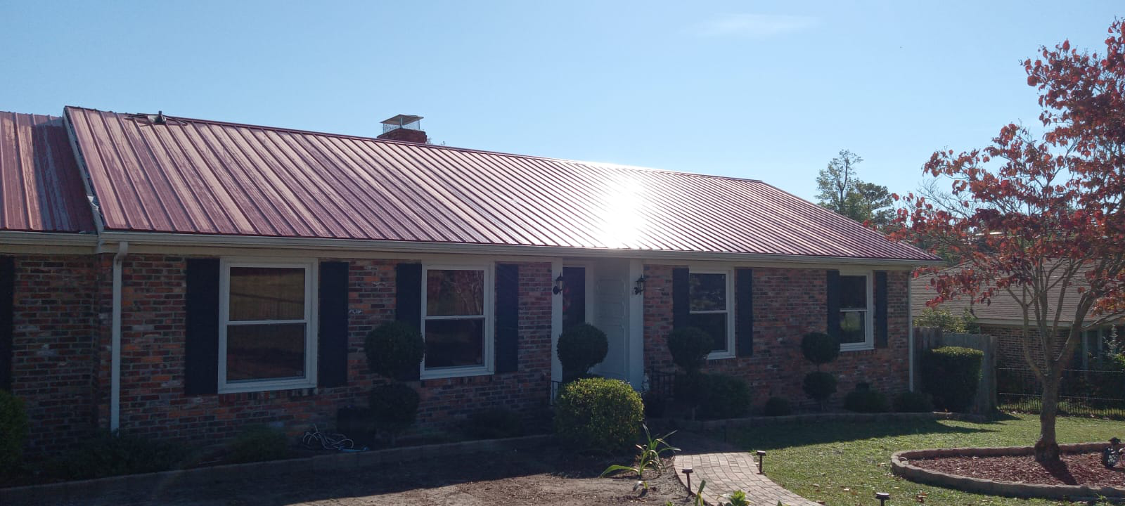 A red metal roof against the blue sky