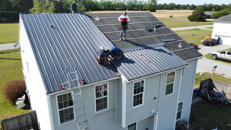 People installing a metal roof